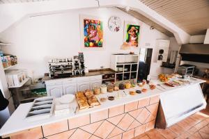 a kitchen with a counter with food on it at Arena Surf Hotel in Somo