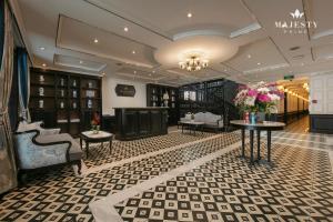a salon with two tables and chairs and flowers at Majesty Luxury Prime Cruise by Premier Group in Ha Long
