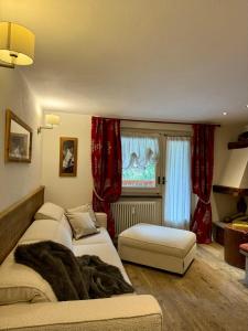 ein Schlafzimmer mit zwei Betten und einem Fenster mit roten Vorhängen in der Unterkunft The Courma - warm 4 family with Mont Blanc view in Verrand