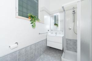 a white bathroom with a sink and a shower at Villa Aquarium in Desenzano del Garda +33 photos