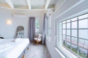 a bedroom with a bed and a large window at Villa Aquarium in Desenzano del Garda