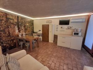 a kitchen and dining room with a table and a refrigerator at Tavernetta vicino Lago Trasimeno in Magione
