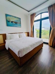 Ένα ή περισσότερα κρεβάτια σε δωμάτιο στο Rose Hill Hotel Phú Quốc