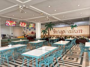 a restaurant with blue tables and blue chairs at Pattaya Park Beach Resort in Pattaya South