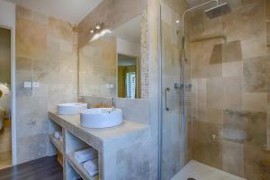 a bathroom with two sinks and a shower at La Maison D'hana in Saint-Bonnet-de-Valclérieux +10 photos