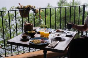 a table with plates of food on a balcony at BYPILLOW Cap Sa Sal in Begur