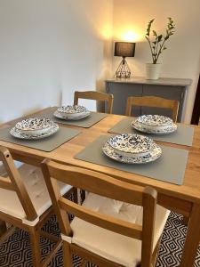 a wooden table with four chairs and plates on it at Stay In Bar in Bar +12 photos