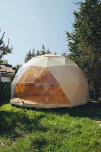 a tent sitting in the grass in a field at Arena Surf Hotel in Somo