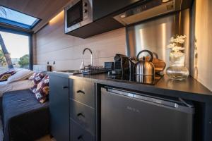 a kitchen with a sink and a stove in a room at Cabañas en el bosque cerca de Barcelona in Talamanca