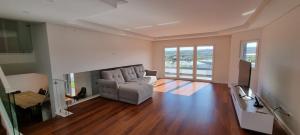 a living room with a couch and a fireplace at Villa Lina in Lourinhã
