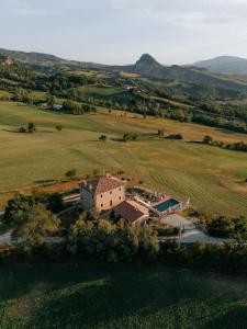 an aerial view of a house in a field at Palazzo Serre - Natura & Piscina in San Leo