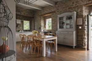 a kitchen and dining room with a table and chairs at Palazzo Serre - Natura & Piscina in San Leo +35 photos