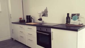 a kitchen with a counter top with a black oven at Ferienhaus Senta in Haßloch