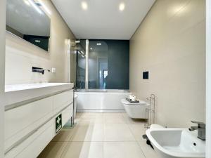 Faro Prestige by Homing في فارو: حمام مع حوض استحمام ومغسلة ومرحاض +31 صورة