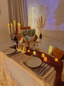 a table with plates and wine glasses on it at Huế Nestory Homestay in Thôn Trường Giang +19 photos