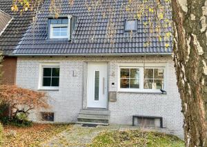 杜塞尔多夫Ruhiges und citynahes Dachgeschoss-Nest的白色砖屋,有白色的门和窗户