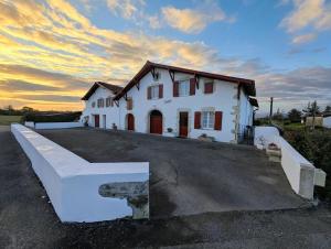 a white house with a sunset in the background at Loustaou in Bidache +26 photos