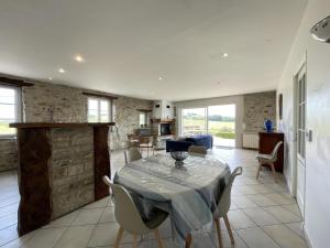 a kitchen and living room with a table and chairs at Loustaou in Bidache