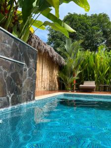 a swimming pool in front of a resort at Casa Adam in Pochote