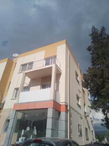 a building with a car parked in front of it at Daire in Kaimakli