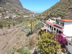 a house on the side of a hill with a mountain at Casa Lara in Hermigua