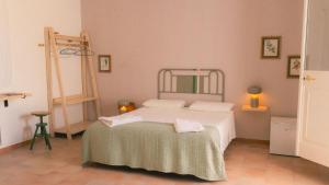 a bedroom with a white bed and a mirror at Tenuta Doxi in Gallipoli