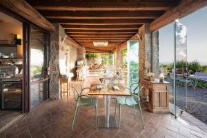 a dining room with a table and chairs on a patio at Be Vedetta - Relais & Glamping - Adult Only in Scarlino