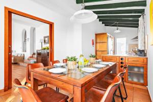 a dining room with a wooden table and chairs at Villa Casa Bonita by Villa Plus in Alaior
