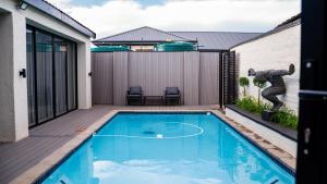 a swimming pool in the backyard of a house at Villa On 59 in Giyani