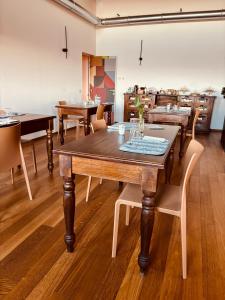 a dining room with a wooden table and chairs at Casale Riversa in Poncarale