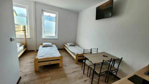 a room with a table and a bed and a dining room at Golenicka Przystań Golenice 73a in Golenice