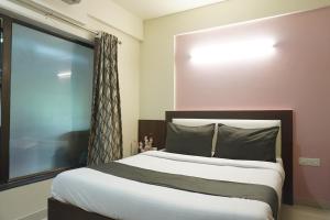 Ένα ή περισσότερα κρεβάτια σε δωμάτιο στο Executive Hotel Pearl Inn