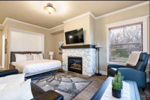 a bedroom with a bed and a fireplace at The Wine Barrel - Shuttle to Blue & Private Patio in Collingwood