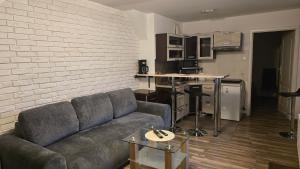 a living room with a couch and a brick wall at Mostowa 3 in Bydgoszcz