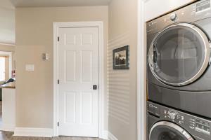 a laundry room with a washer and dryer at The Wine Barrel - Shuttle to Blue & Private Patio in Collingwood