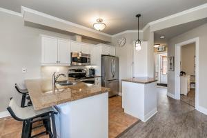 a kitchen with white cabinets and a counter top at The Wine Barrel - Shuttle to Blue & Private Patio in Collingwood