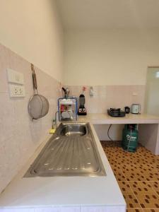 a kitchen with a sink and a counter top at Nazo Boutique Bungalows in Wok Tum +61 photos