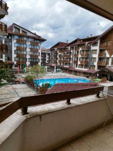 a view of an apartment complex with a swimming pool at Pirin's Hidden Gem BB & SKI & SPA in Bansko