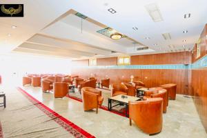 a restaurant with chairs and tables in a room at Giza Inn Comfort view in Cairo
