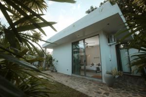 a modern house with a glass facade at Nico Villa in Ahangama