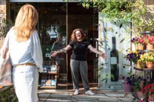 a woman standing in front of a store at Be Vedetta - Relais & Glamping - Adult Only in Scarlino