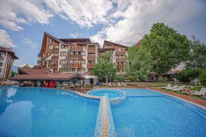 a large swimming pool in front of a building at Pirin's Hidden Gem BB & SKI & SPA in Bansko