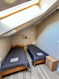 a bedroom with two beds in a small room at MOSiR Reda in Reda