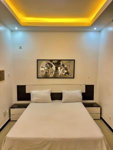 a bedroom with a large bed with two pillows at Classimo in Dakar