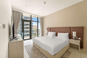 Giường trong phòng chung tại Stylish 1BR in Palm Jumeirah with Rooftop Pool