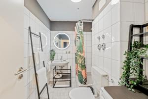 a bathroom with a sink and a toilet at Goldstadt Fancy Apartment in Pforzheim +54 photos
