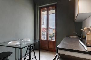 cocina con mesa y puerta con ventana en Casa Rinchiosa, en Marina di Carrara