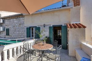 マカルスカにあるVilla Old Town Centre Makarska - Makarska Exklusivのバルコニーにテーブルと椅子が置かれたパティオ