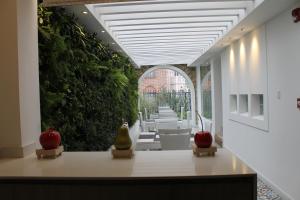 an open hallway with white chairs and apples on a table at Casa Hotel Boyaca Real in Bogotá