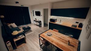 a living room with a couch and a table at De Konik in Uikhoven